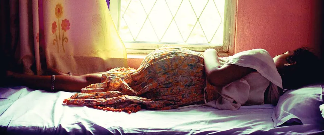 Make Women and Girls Safer Appeal image of young woman lying on a bed